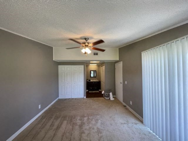 an empty living room with a ceiling fan