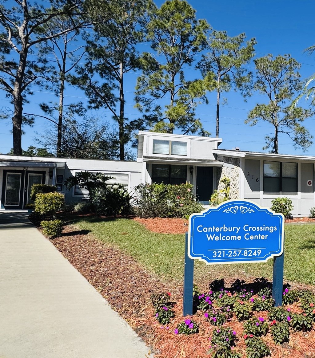 A Canterbury Crossings Welcome Center sign in front of a building.