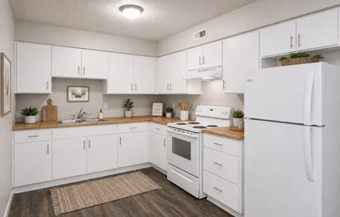 A white kitchen with a refrigerator on the right.