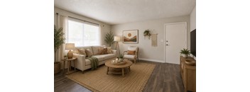 A living room with a white couch, a wooden coffee table, and a painting on the wall.