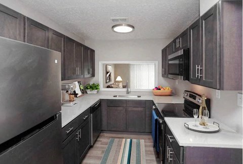 a kitchen with stainless steel appliances and wooden cabinets