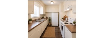A kitchen with white appliances and wooden cabinets.
