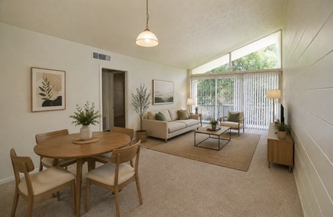A living room with a dining table and chairs.