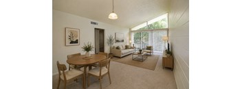 A living room with a dining table and chairs.