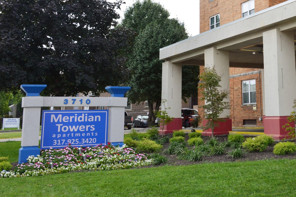 the front of a building with a sign for meridian towers apartments