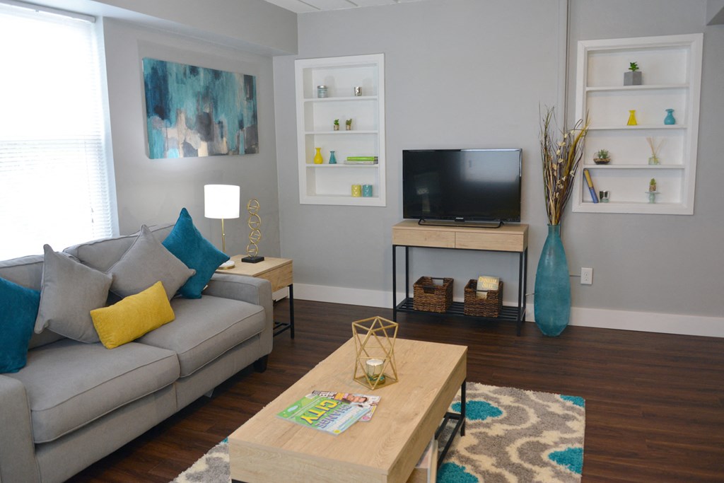a living room with a couch and a coffee table and a television