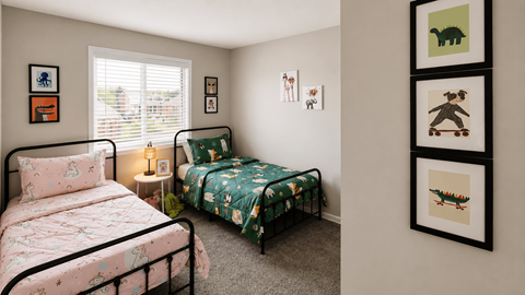 A bedroom with two beds and a wall of framed pictures.