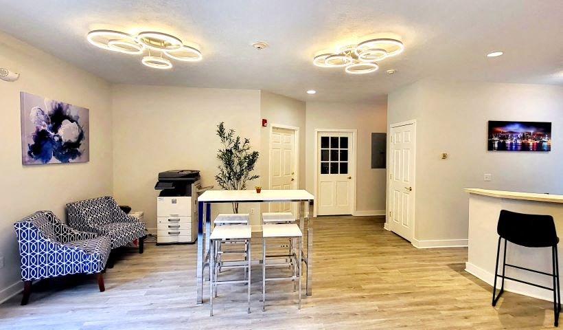 a room with a table and chairs and a couch