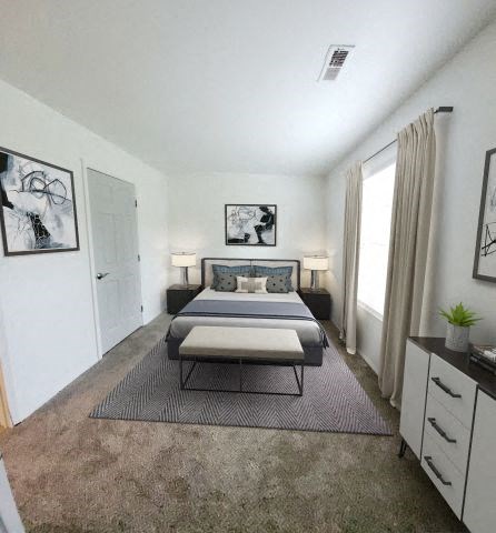 a bedroom with a bed and a rug