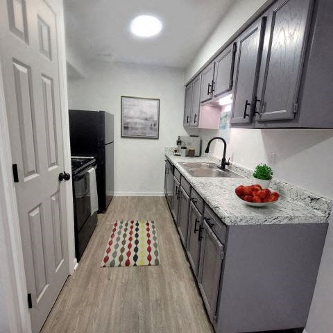 a kitchen with a sink and a refrigerator