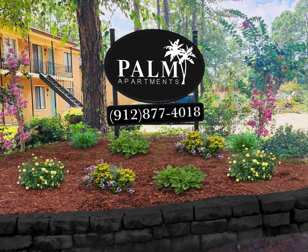 a picture of a garden with a sign that says palm apartments