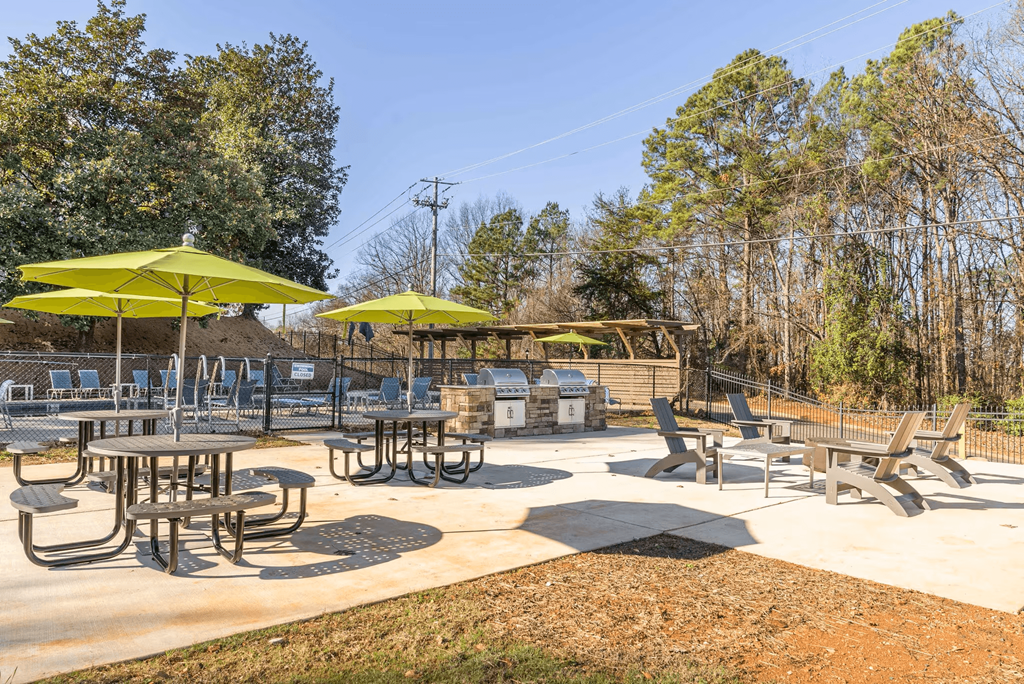 A sunny day at the outdoor picnic area with tables and chairs.