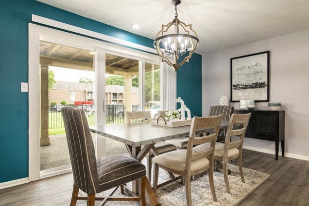 a dining room with a table and chairs and a large window