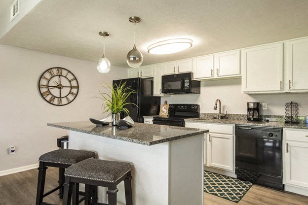 a kitchen with a counter top with two stools