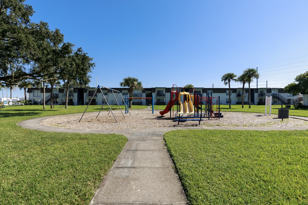 a playground in a park in front of a building