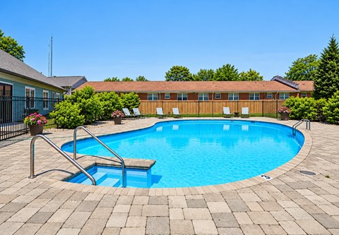 A small pool with a ladder in the middle of it.