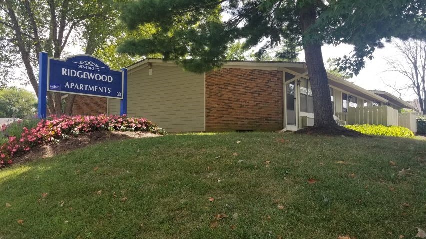 a building with a redwood apartments sign in front of it