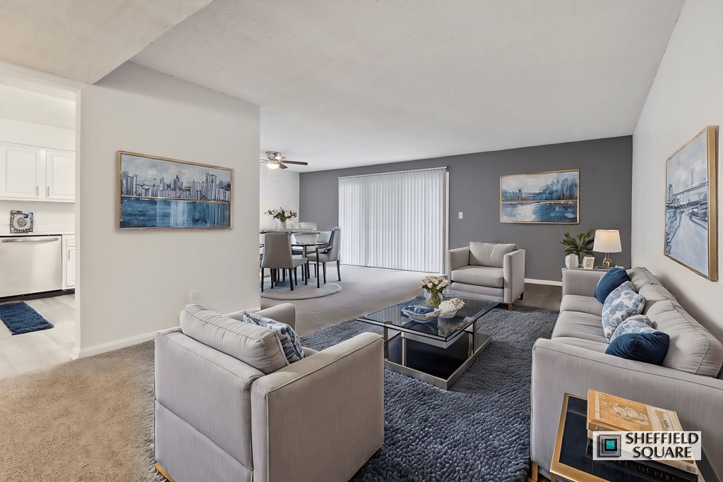 A living room with a grey couch and a coffee table.