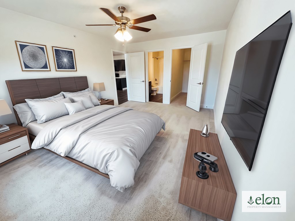 A bedroom with a large bed and a flat screen TV mounted on the wall.