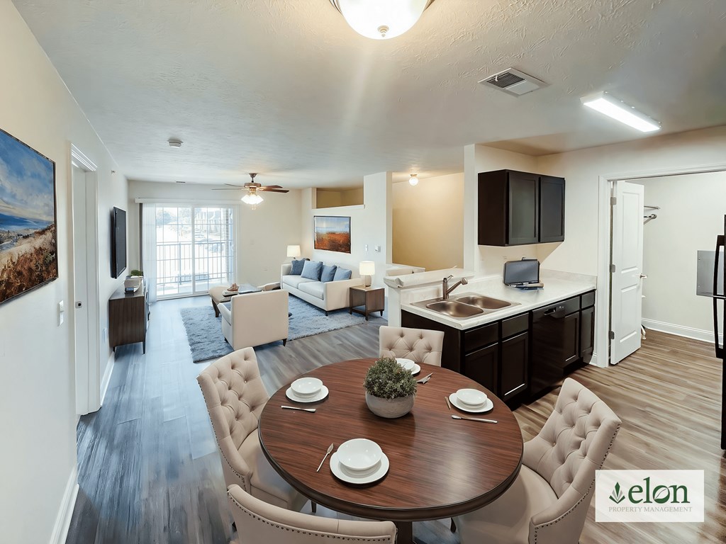 A dining room with a wooden table surrounded by chairs.