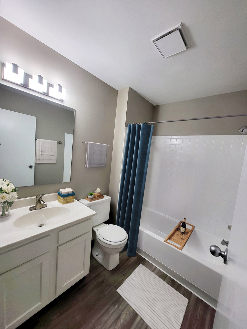 a bathroom with a toilet sink and tub and a mirror