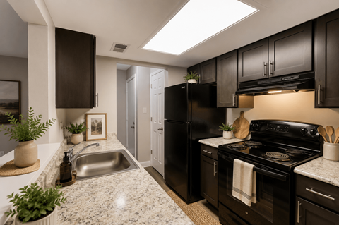 A kitchen with black appliances and brown cabinets.