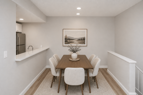 A dining room with a wooden table and chairs.