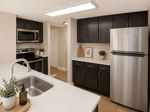 A kitchen with a white counter top and a stainless steel refrigerator.