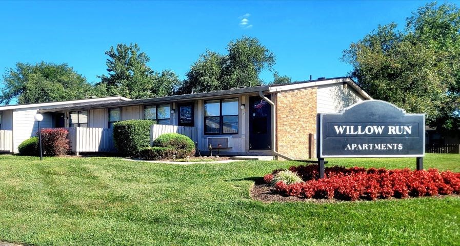 a building with a sign for willow run apartments