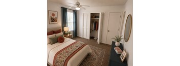 A bedroom with a large bed and a ceiling fan.