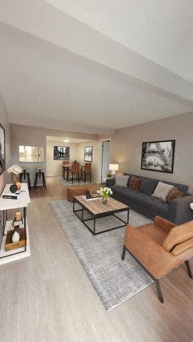 Spacious living room with hardwood-style flooring next to the dining area.  