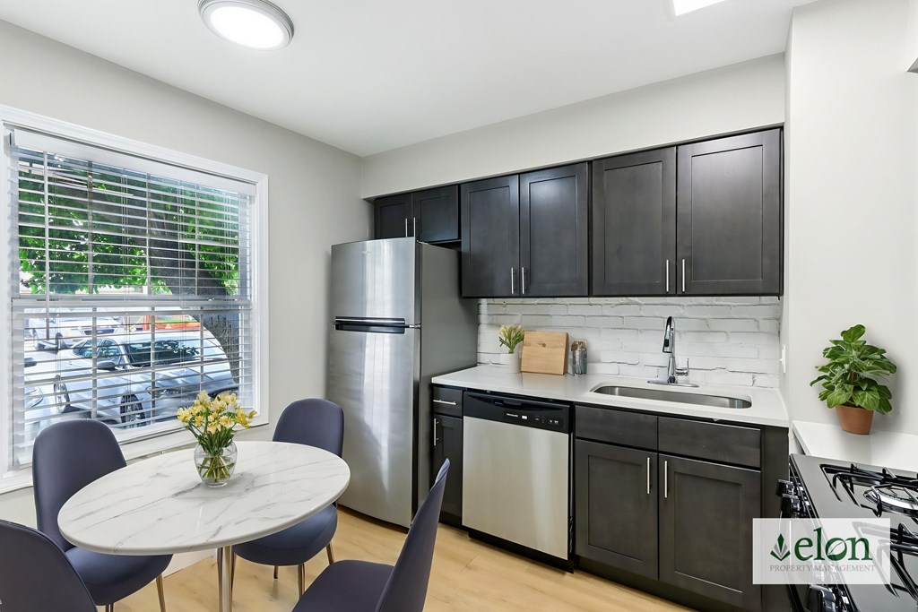 A modern kitchen with a dining table and chairs.