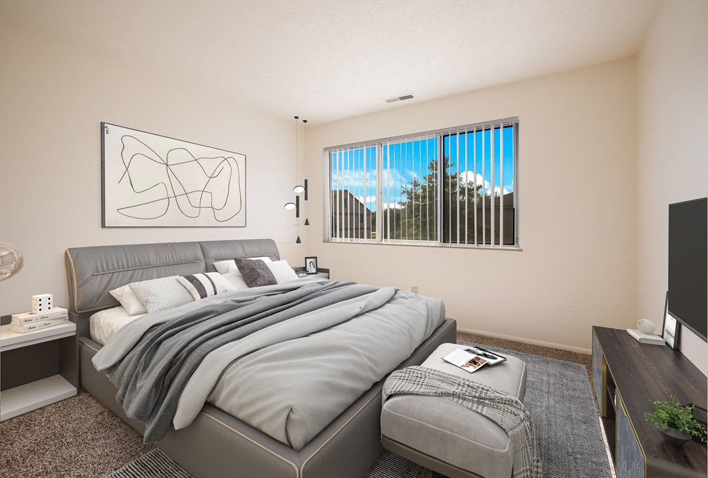 a bedroom with a large bed and a large window