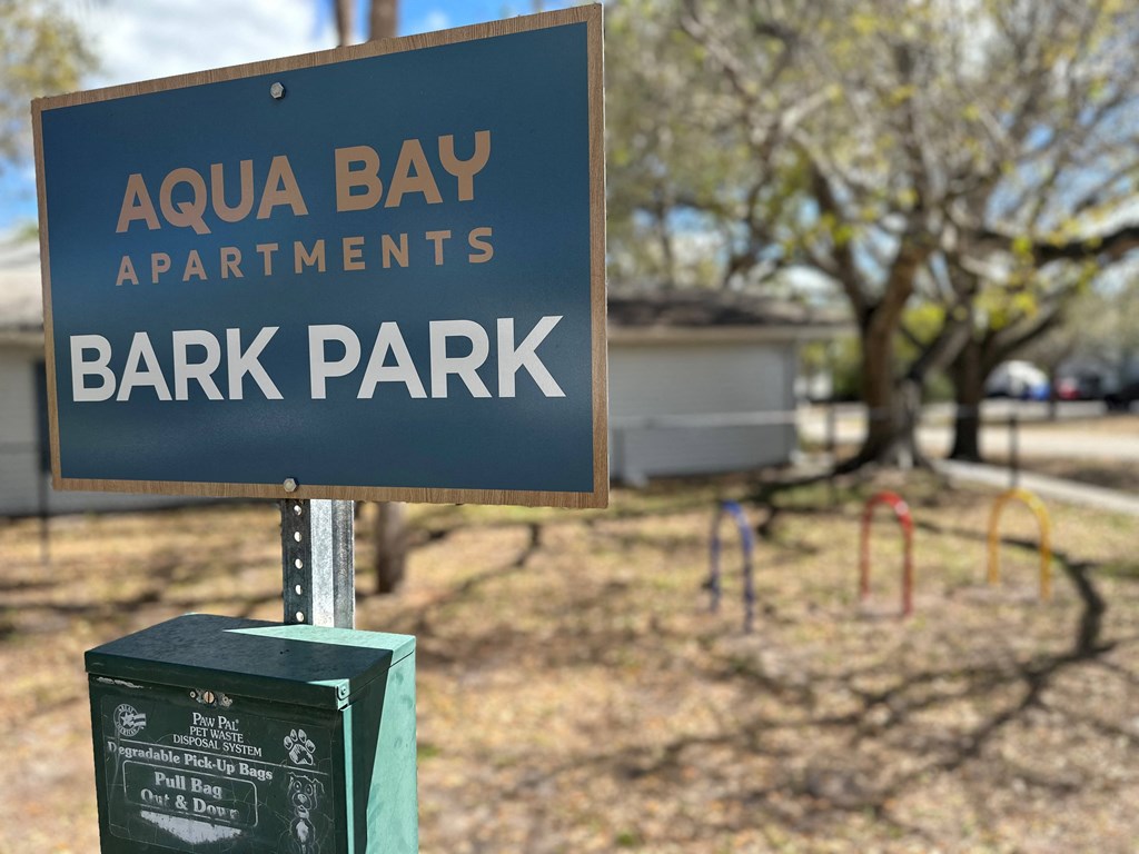 a sign for the Bark Park at Aqua Bay Apartments in Naples, FL 34116