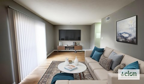 A living room with a couch, a coffee table, a television, and a painting on the wall.