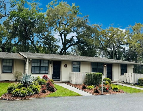 A house with a well-maintained garden in front.