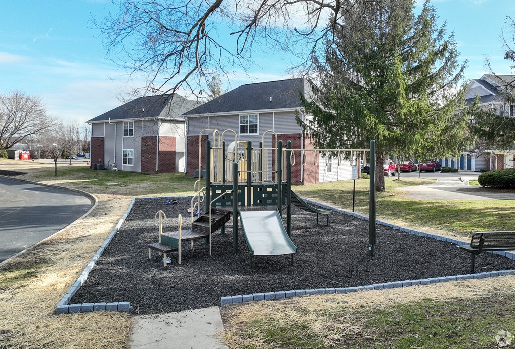 a playground in a park in front of a house