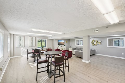 A dining room with a table and chairs.