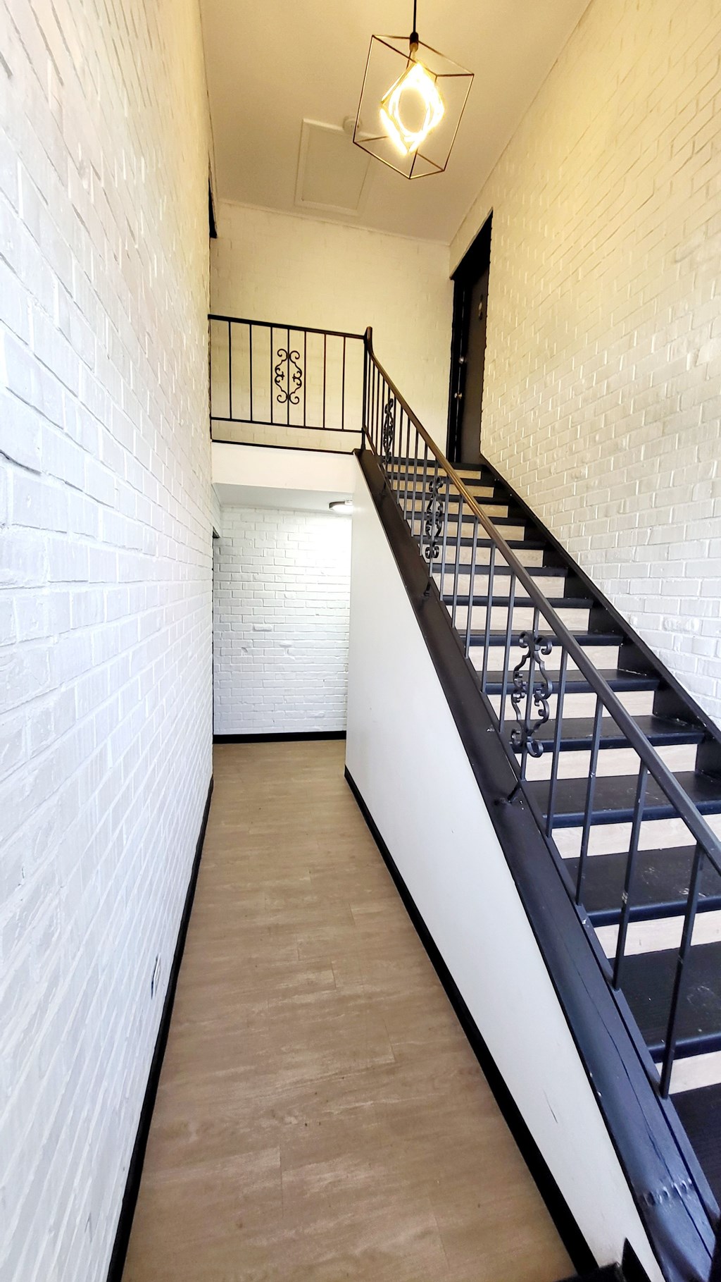 A long hallway with a staircase on the right side.