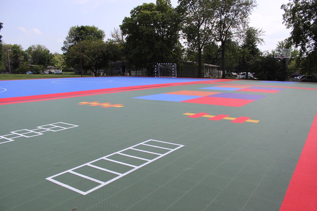 A green surface with red and blue lines and symbols.