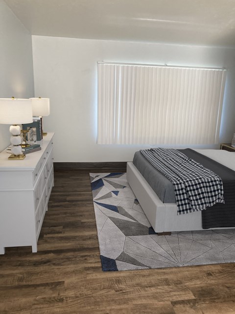 a bedroom with a bed and a dresser