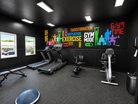 A gym with a variety of equipment and motivational wall decals.