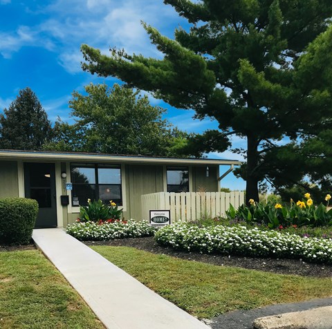 A building with a sign that says "Welcome" in front of it.