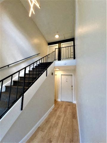 Interior of The Hub at Nora apartment building with black stairs. 