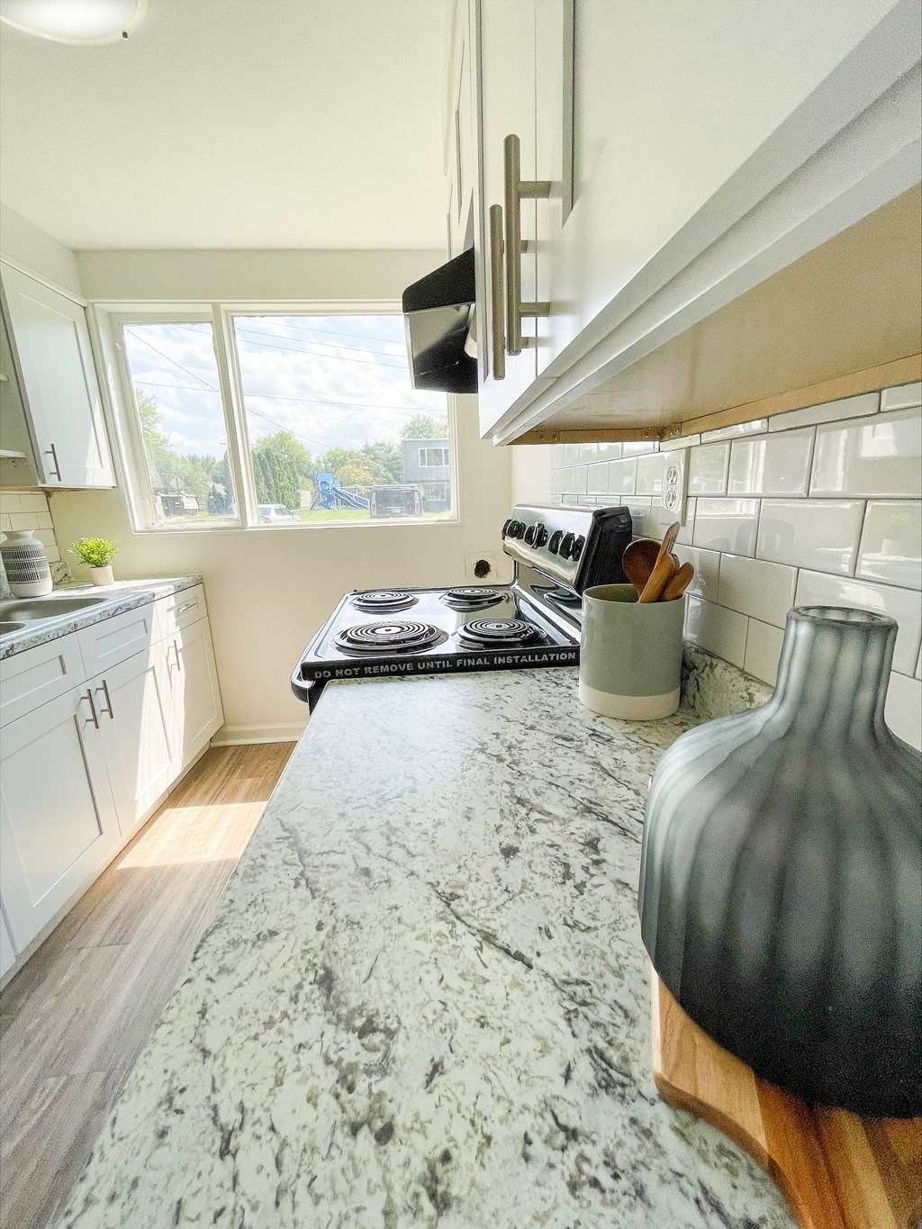 a kitchen with a marble counter top and a stove at Townhomes at 28th, Columbus, IN, 47201