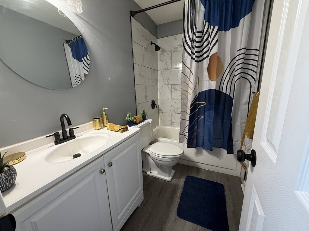 A bathroom with a white sink and toilet.