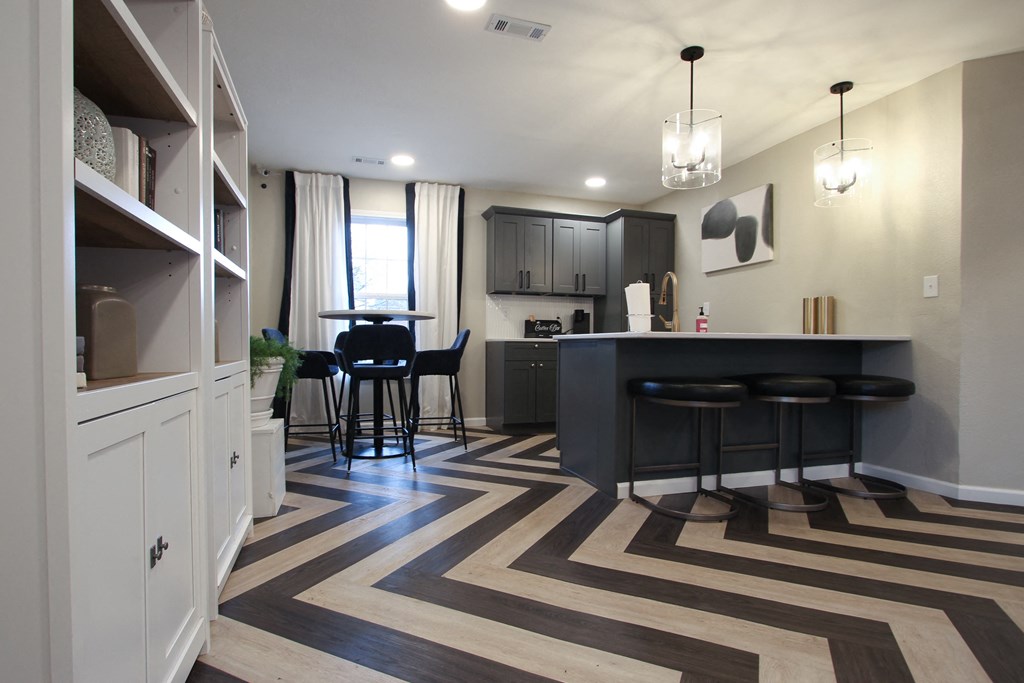 a kitchen and living room with a bar and a striped rug