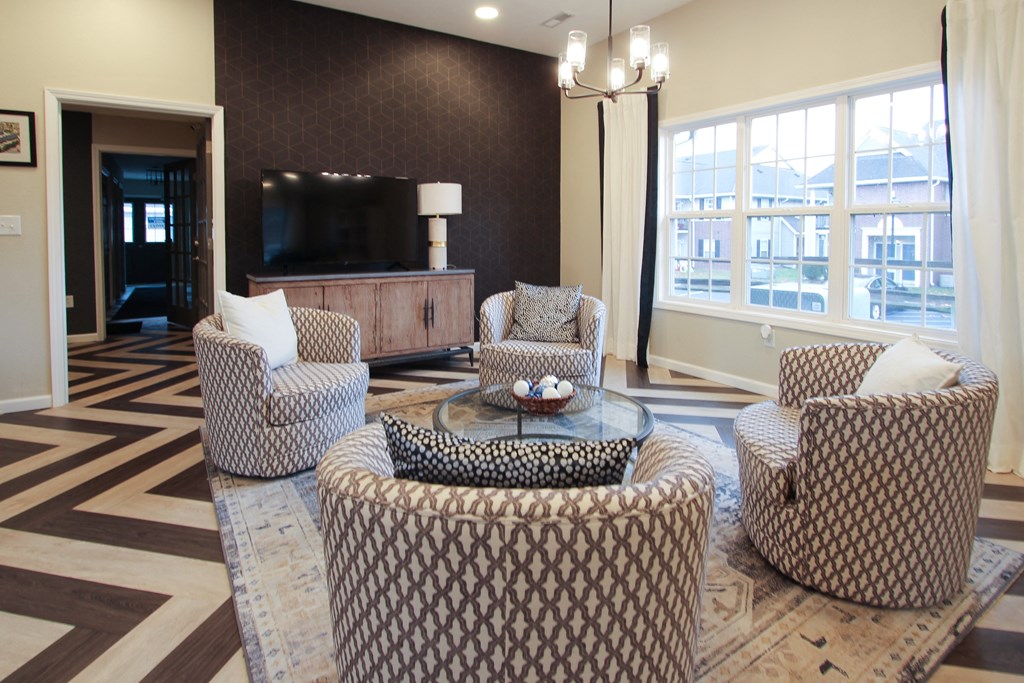 a living room with couches and chairs and a television