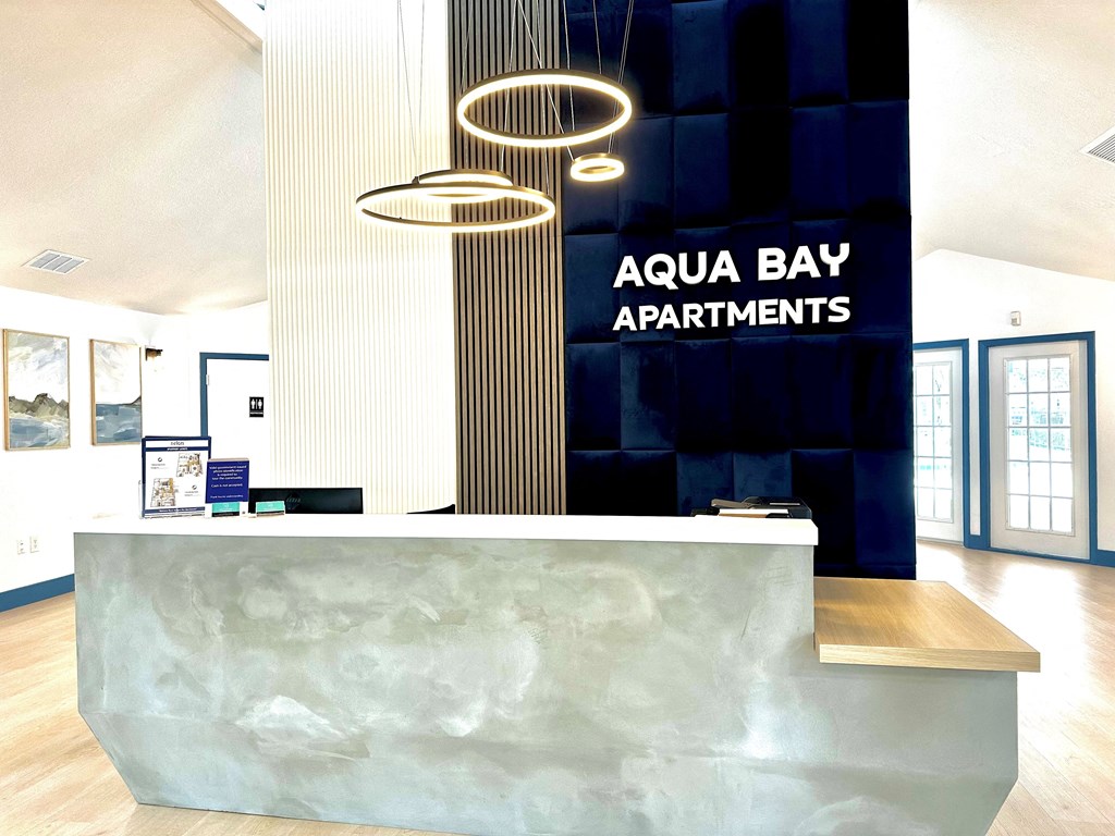 A reception area with a desk at Aqua Bay Apartments in Naples, FL 34116
