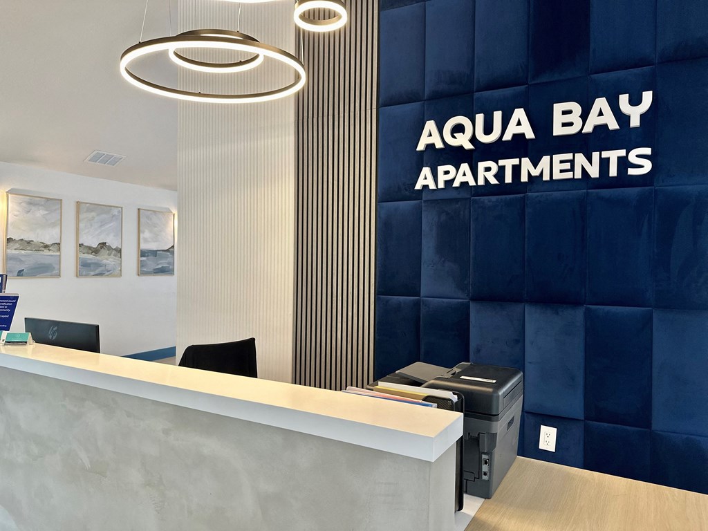 A reception area with a desk at Aqua Bay Apartments in Naples, FL 34116